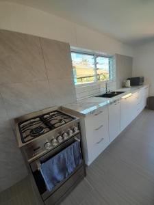 a kitchen with a stove and a sink in it at PohatuOkoro in Arorangi +15 photos