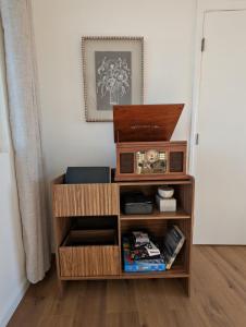 a wooden book shelf with a radio on it at Golden Moon Hideaway in Twentynine Palms