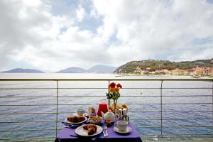 a table with food and flowers on top of a boat at Hotel San Terenzo in Lerici