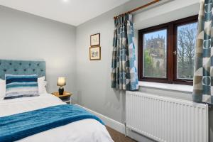a bedroom with a bed and a window at The Forge in Castleton