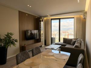 a living room with a couch and a table at Giselle Escape in Tirana