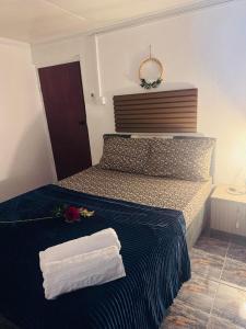 a bedroom with a bed with two towels on it at Master's Homestay in Suva