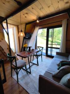 a living room with a couch and a table at Chale Pepê in Campo Alegre