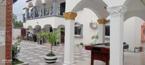 a courtyard with a pool table in a house at Cutting Edge Guest House in Daranka