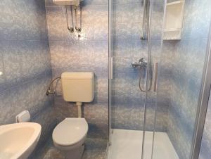 a bathroom with a toilet and a glass shower at Seaside apartments with a swimming pool Nin, Zadar - 6153 in Nin +42 photos