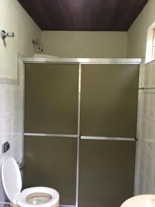 a shower stall in a bathroom with a toilet at um pedaço do paraíso in São Roque +4 photos