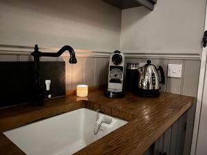 a kitchen counter with a sink and a mixer at Poachers Hut at Keepers Cottage - Hot Tub & Pizza Oven - Trossachs in Port of Menteith +27 photos