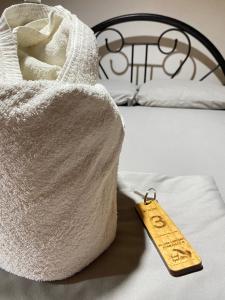 a towel on a bed with a tag on it at Alona Chrisah Apartelle in Panglao Island