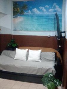 a bedroom with a bed with a painting on the wall at Mistela Altos Crucero Boutique - Alojamiento temático - Zona Residencial Ciudad - Viajes al Aeropuerto - in Godoy Cruz
