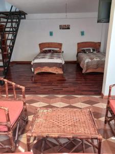 a living room with two beds and a staircase at La Fábula-Naranja in Copacabana