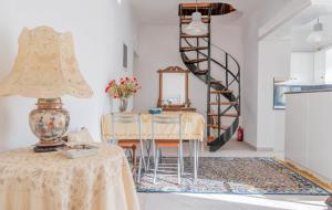 a living room with a table and a spiral staircase at Villa Luna in Káto Ássos