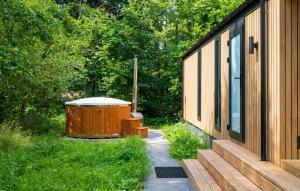 a hot tub sitting next to a house at Sernets Recreatie Chalet 111 in Oud-Gastel +12 photos