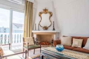 a living room with a couch and a fireplace at Villa Luna in Káto Ássos