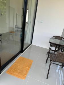 a room with chairs and a rug on the floor at Mina House in Thong Nai Pan Yai