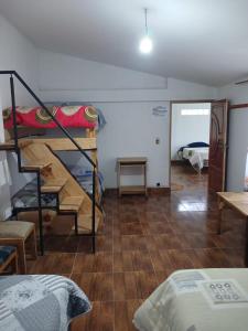 a room with bunk beds and a room with a bedroom at La Fábula-Verde Limón in Copacabana