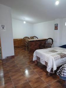 a bedroom with a bed and a table and chairs at La Fábula-Verde Limón in Copacabana
