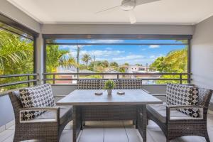 a table and chairs on a balcony with a view at Palmy Villa in Gold Coast