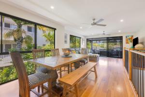 a dining room with a wooden table and chairs at Palmy Villa in Gold Coast