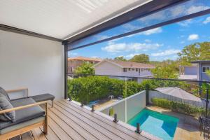 a balcony with a view of a swimming pool at Palmy Villa in Gold Coast