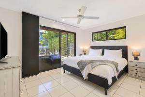 a bedroom with a bed and a television in it at Palmy Villa in Gold Coast +16 photos
