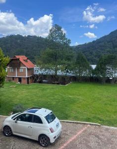 a white car parked in front of a house at Cabaña El real in Cedro +5 photos