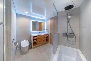 a bathroom with a shower and a toilet and a sink at Sakuraya in Hakuba +41 photos