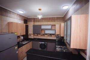 a small kitchen with a washer and dryer in it at Star Luka in Luxor