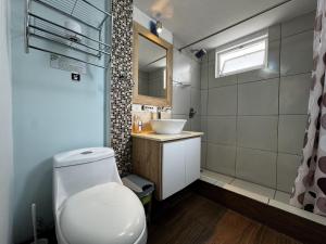 ein Badezimmer mit weißer Toilette und Waschbecken in der Unterkunft Hotel Shalom in Riobamba + 107 Fotos