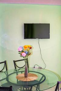 a glass table with a vase with flowers on it at mango suites in Portsmouth
