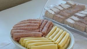 a plate of hot dogs and cheese on a table at Casa das Luzes Hostel IVN in Rio de Janeiro +45 photos