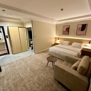 a hotel room with a bed and a couch at نسيم الحرم in Ash Shishah +23 photos