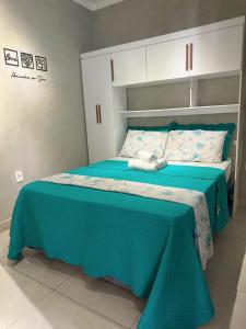 a bedroom with a bed with a blue comforter at Refúgio com Fogueira, Piscina, Bilhar e Ar condicionado in Nova Odessa +37 photos