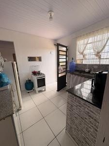 a kitchen with a counter and a stove in it at Chácara Pagliai e Bueno in Suzano
