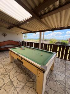 a pool table sitting on a patio at Chácara Pagliai e Bueno in Suzano