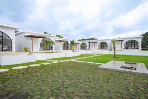 an exterior view of a white building with a yard at Lazura Serenite in Bangli +24 photos