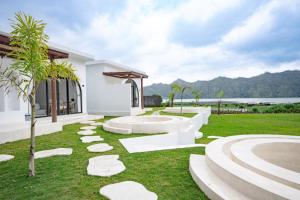 a garden with rocks on the grass next to a building at Lazura Serenite in Bangli