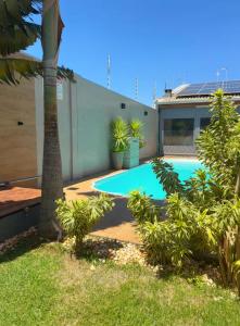 a swimming pool in the backyard of a house at Refúgio com Fogueira, Piscina, Bilhar e Ar condicionado in Nova Odessa