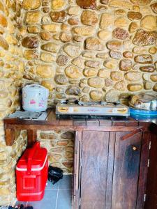a stone wall with a table with a appliance on it at Holy Villa in Kampot