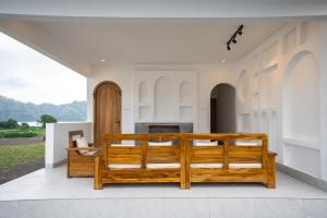 a bedroom in a house with a wooden bed at Lazura Serenite in Bangli