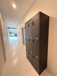 a row of lockers in a room with a hallway at Bingo Hostel Khao Sok in Khao Sok National Park