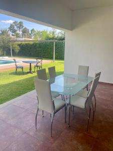 a glass table and chairs in a patio at Oasis Tequisquiapan in Tequisquiapan