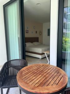 a wooden table and chairs in a room with a bed at Lux Condo Anah Downtown in Playa del Carmen +16 photos