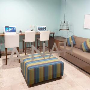 a living room with a table with two laptops on it at Lux Condo Anah Downtown in Playa del Carmen
