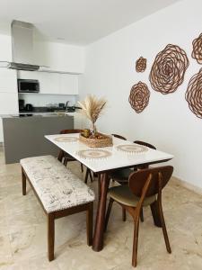 a dining room table and chairs in a kitchen at Lux Condo Anah Downtown in Playa del Carmen