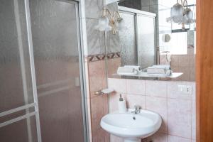 a bathroom with a sink and a shower at Moty's Guesthouse in Cusco