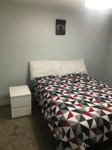 a bedroom with a black and white bed and a nightstand at Utah Housing in South Jordan