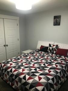 a bedroom with a black and white comforter on a bed at Utah Housing in South Jordan