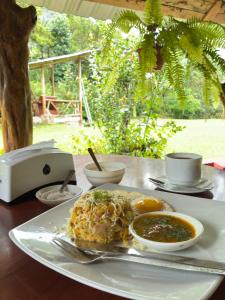 a plate of food on a table with a plate of food at Mindo Garceta Sol in Mindo