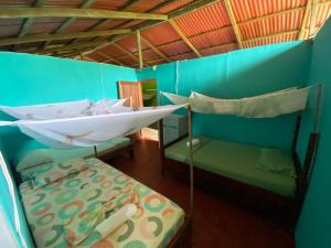 a room with two bunk beds and a bed at Posada Kevelin in Termales - agua caliente - nuqui