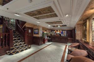 a lobby with a bar and stairs in a building at Britannia Hotel Birmingham New Street Station Birmingham in Birmingham